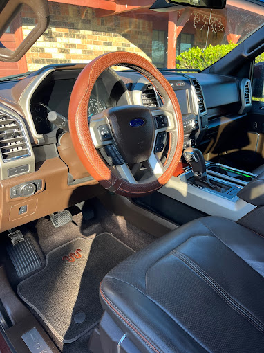 The interior of a car with a steering wheel