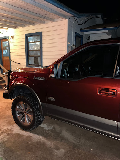 A red truck parked in front of a house