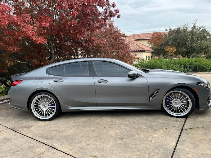 A silver sports car parked in a driveway