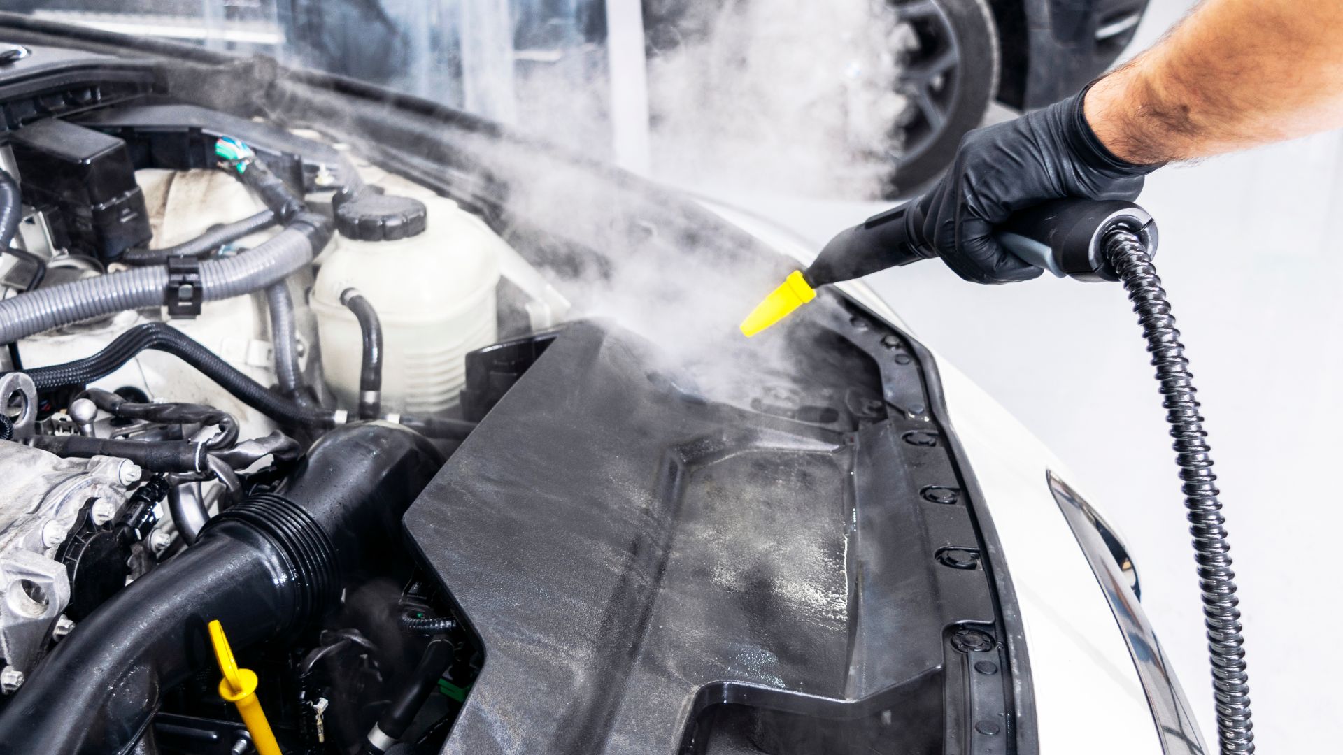 A car being cleaned with a high pressure washer